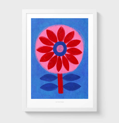 A colorful art print featuring a stylized flower with a red corona and blue petals on a blue background, framed in a white border.