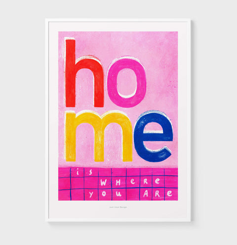 Bold and colorful Typography poster featuring an illustrated phrase saying "home is where your are" with vibrant pink, red and yellow color palette.