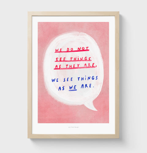 Inspirational wall art featuring a hand painted bold speech bubble and inside a hand drawn typography quote saying "we do not see things as they are, we see things as we are", on warm pink background. Illustrated quote print with painterly style and an inspirational message about reality.