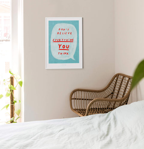 Colorful illustration quote print with hand written typography saying "don't believe everything you think" with turquoise blue and vibrant red color palette. Inspirational wall art about self care and negative self talk.