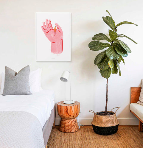 Self love art illustration print featuring a pink hand holding a women. This women empowerment poster is hanging above bed in a modern women's bedroom.