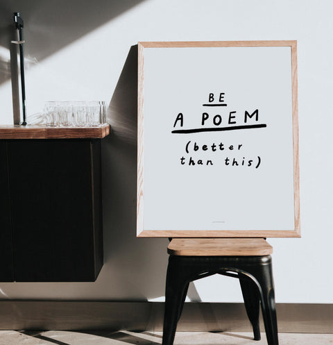 inspirational wall art and  black and white quote posters saying "be a poem, better than this" in a trendy and modern living room