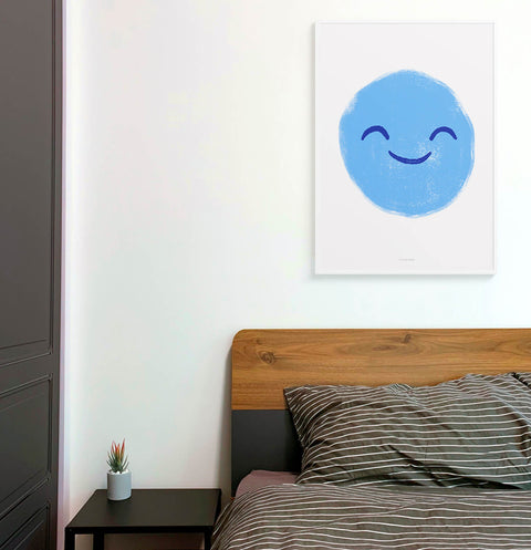 Blue smiling face illustration art print hanging above bed in bedroom.