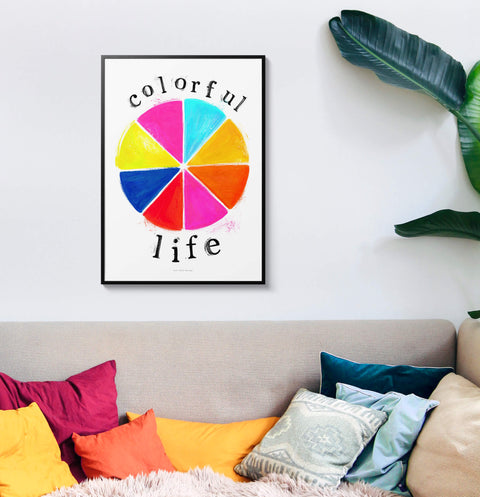 Colorful illustration wall art print with illustrated color wheel in vibrant primary colors and hand painted typography saying "colorful life". Inspirational and positive wall art with uplifting message hanging in colorful interior.