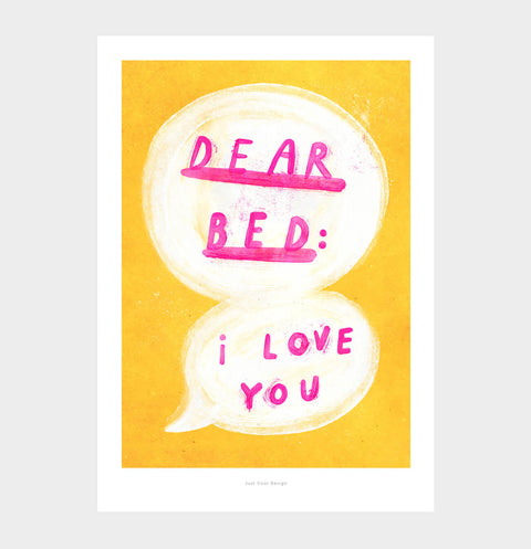 Fun bedroom print for above the bed featuring an illustrated speech bubble and hand painted typography quote saying "dear bed: I love you" with bright yellow and pink colors. The quote print is hanging above the bed.