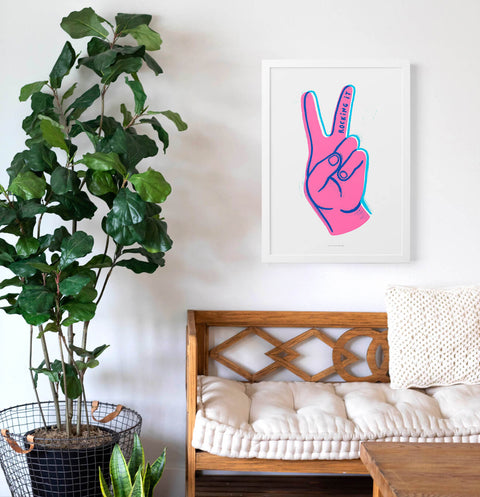 Funky illustration wall art featuring a hand making the victory sign with the fingers. Hand written quote saying "Rocking it"