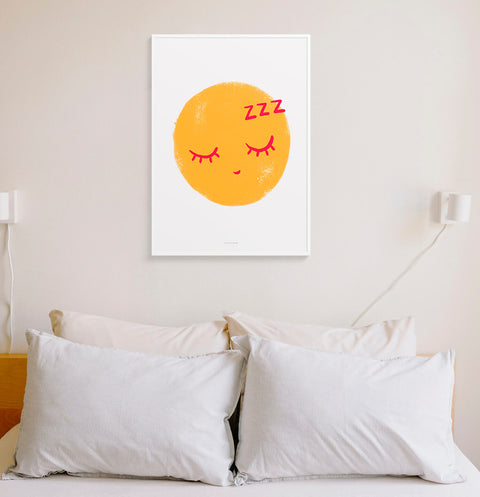 Yellow sleeping emoticon face wall art print hanging above bed in neutral bedroom.